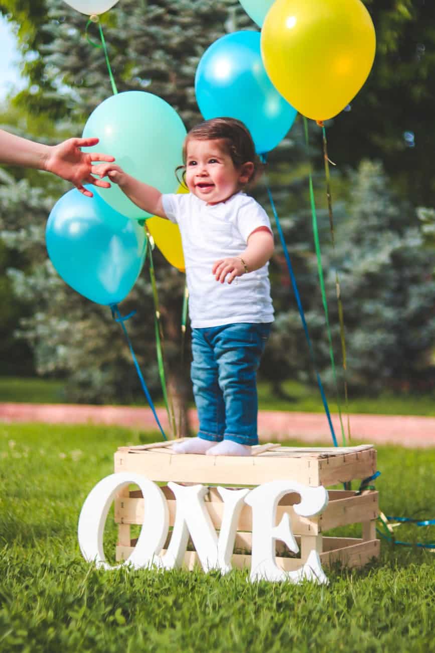 toddler standing on wooden crate