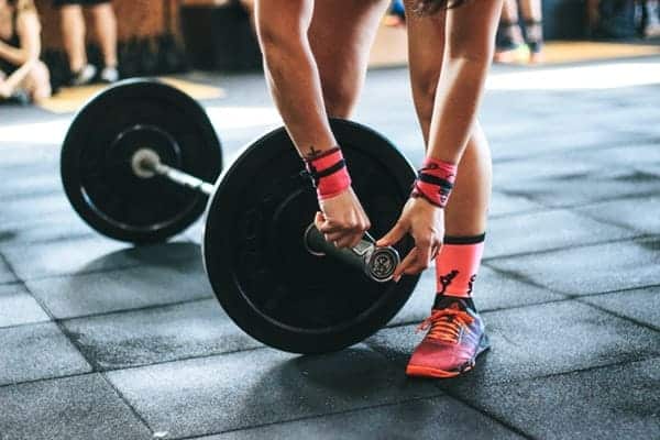 Photo of woman getting ready to deadlift during her fitness routine