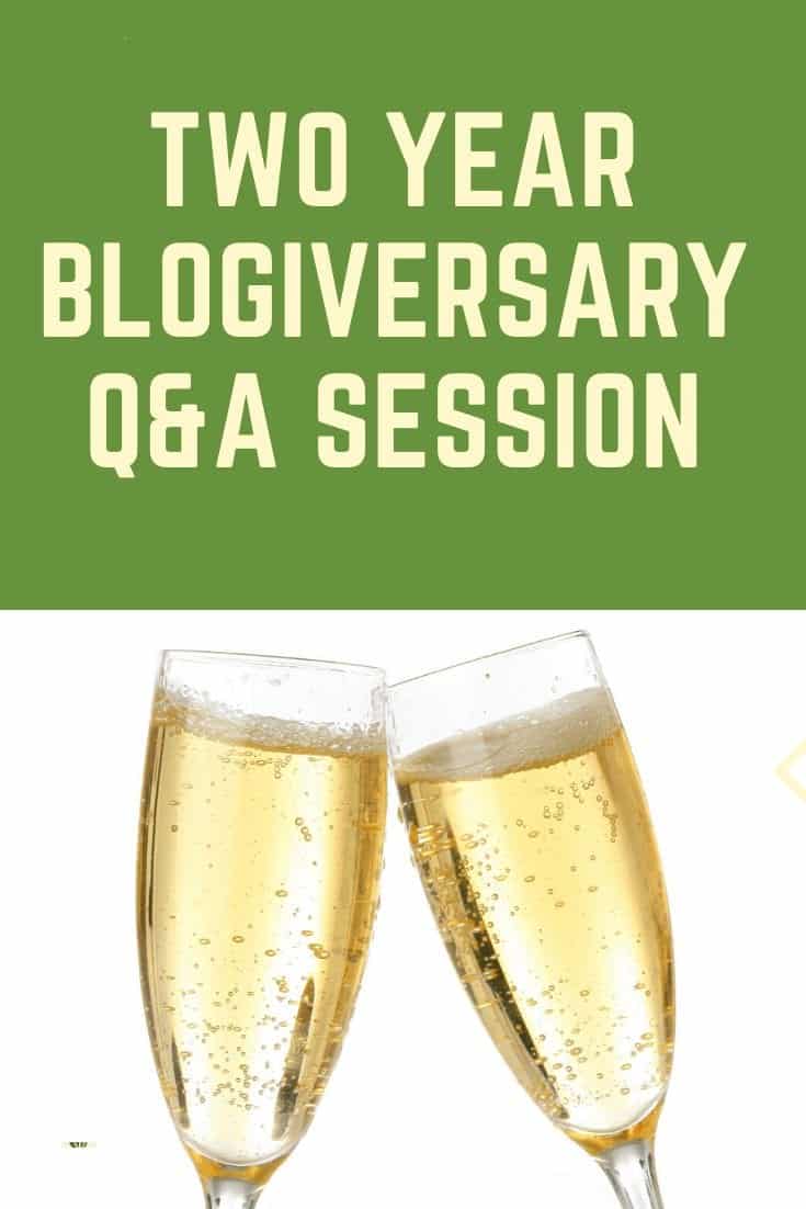 Two year blogiversary Pinterest pin with two champagne classes clanking 