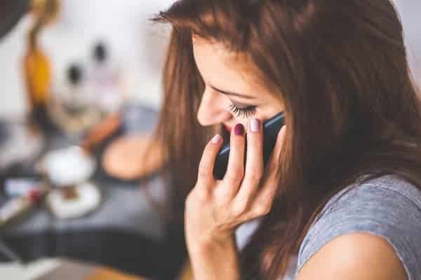 Young Woman talking on the phone leaving a voicemail