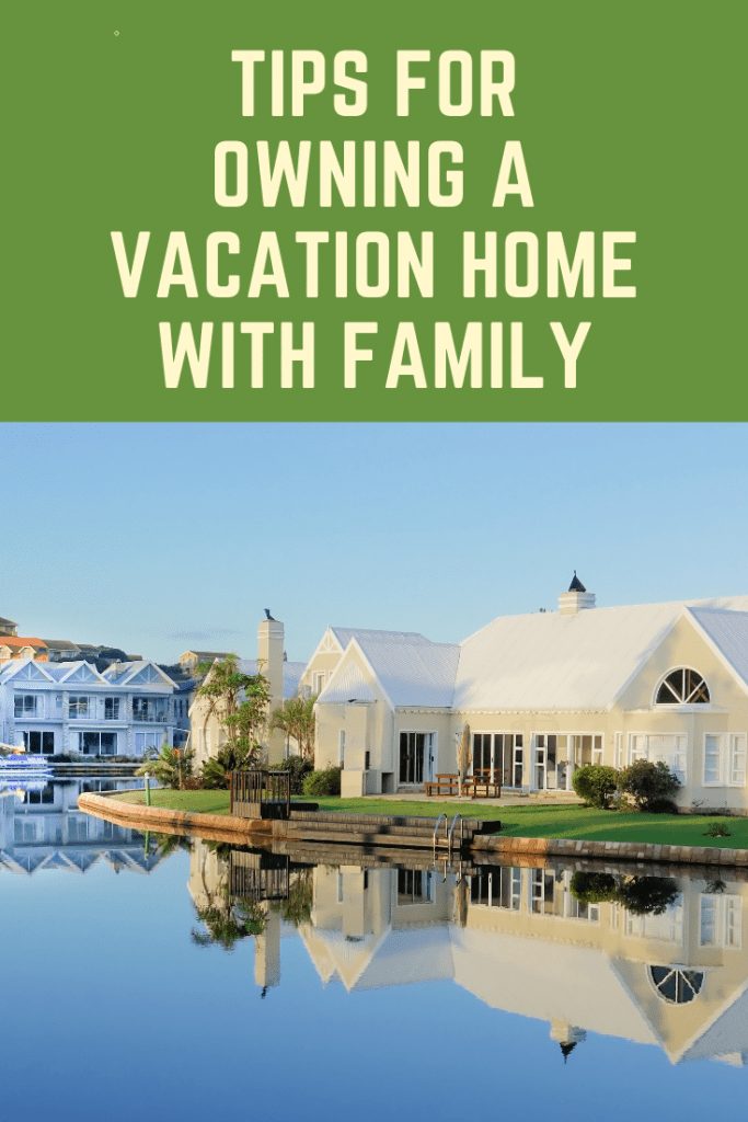 pinterest image of house on lake representing owning a vacation home with family