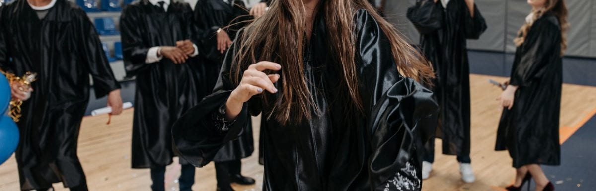 photo of woman wearing graduation gown
