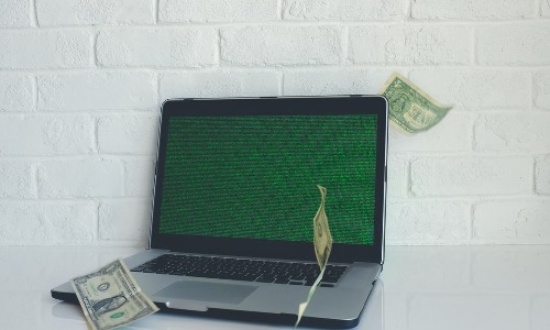 laptop with money showing how to make money with cash app