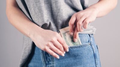 make money quick in one day photo of person putting money in pocket