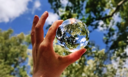 photo of person holding glass ball representing upcycle