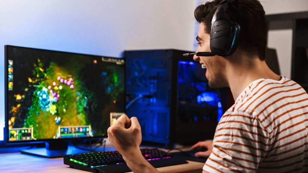 Photo of man playing games on gaming keyboard